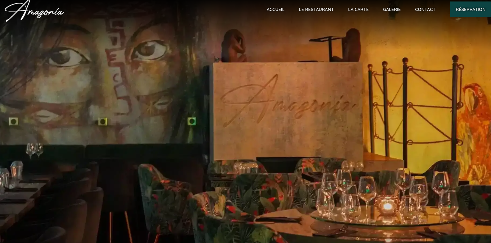 Dimly lit restaurant with mural and elegant table settings.