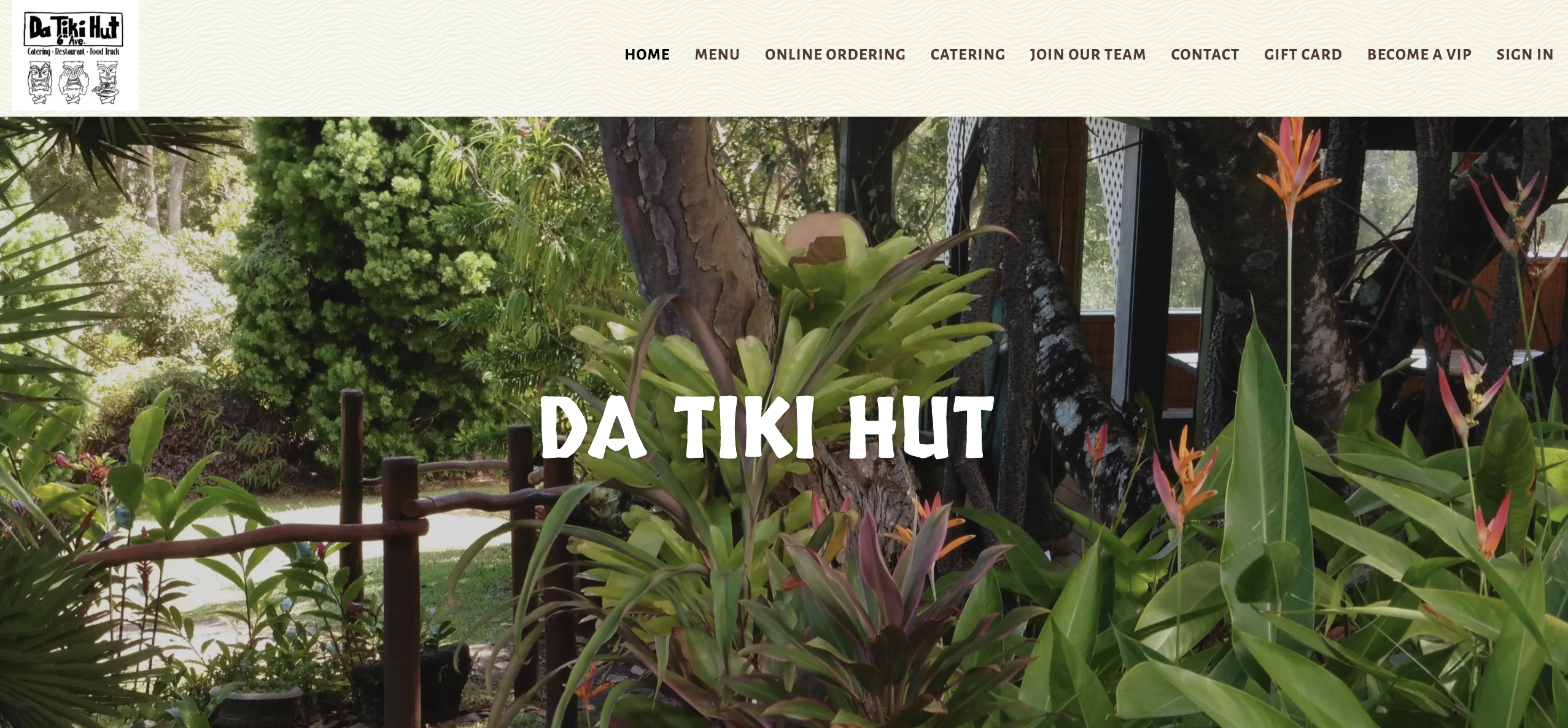 Tropical garden with lush greenery and orange flowers.