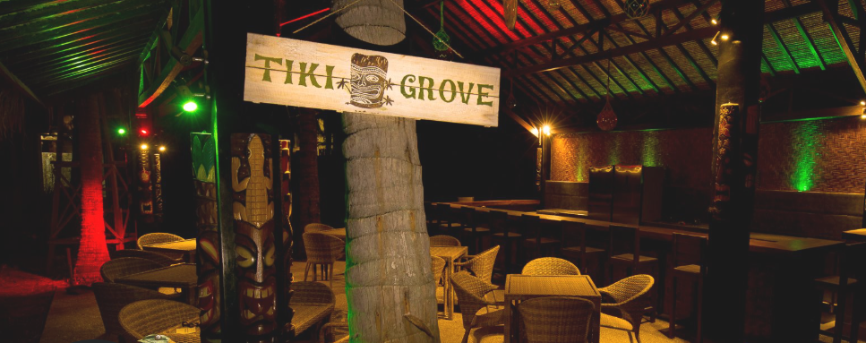 Tiki-themed bar with dim lighting and colorful decor.