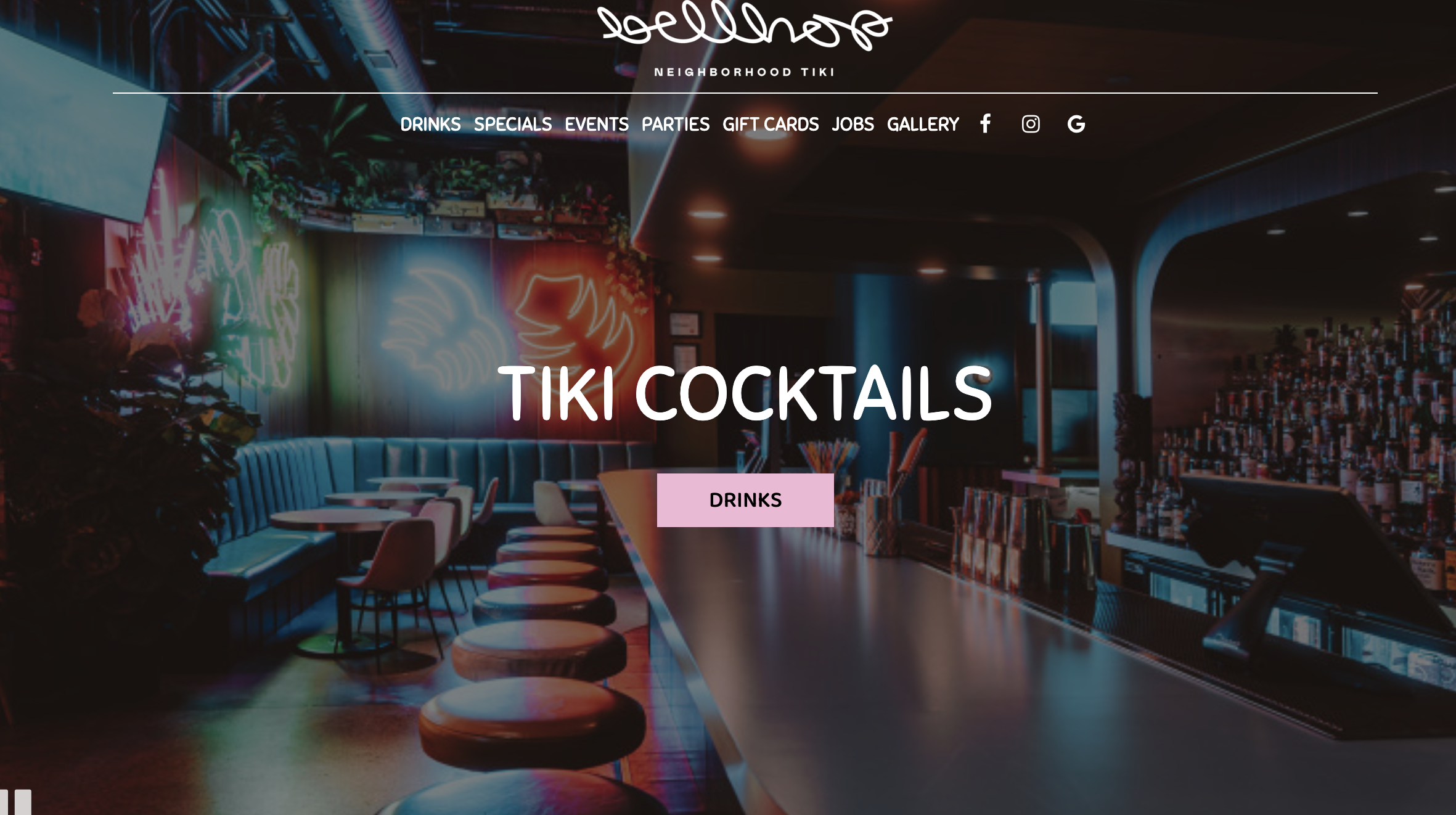 Dimly lit bar with colorful neon lights and a row of bar stools.