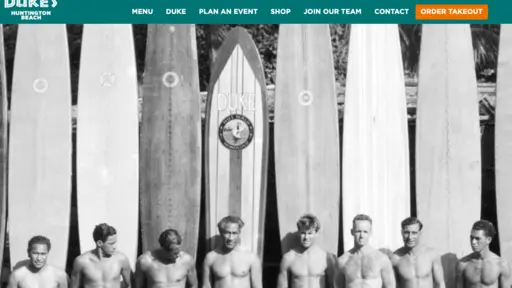 Row of men with vintage surfboards, black and white photo.