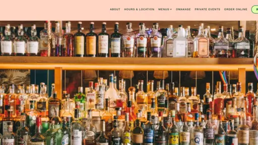 Bar with shelves of assorted liquor bottles, vibrant colors.