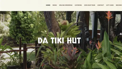 Tropical garden with lush greenery and orange flowers.